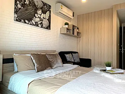 Modern bedroom with stylish decor and cozy ambiance, featuring a comfortable bed and elegant wall art.
