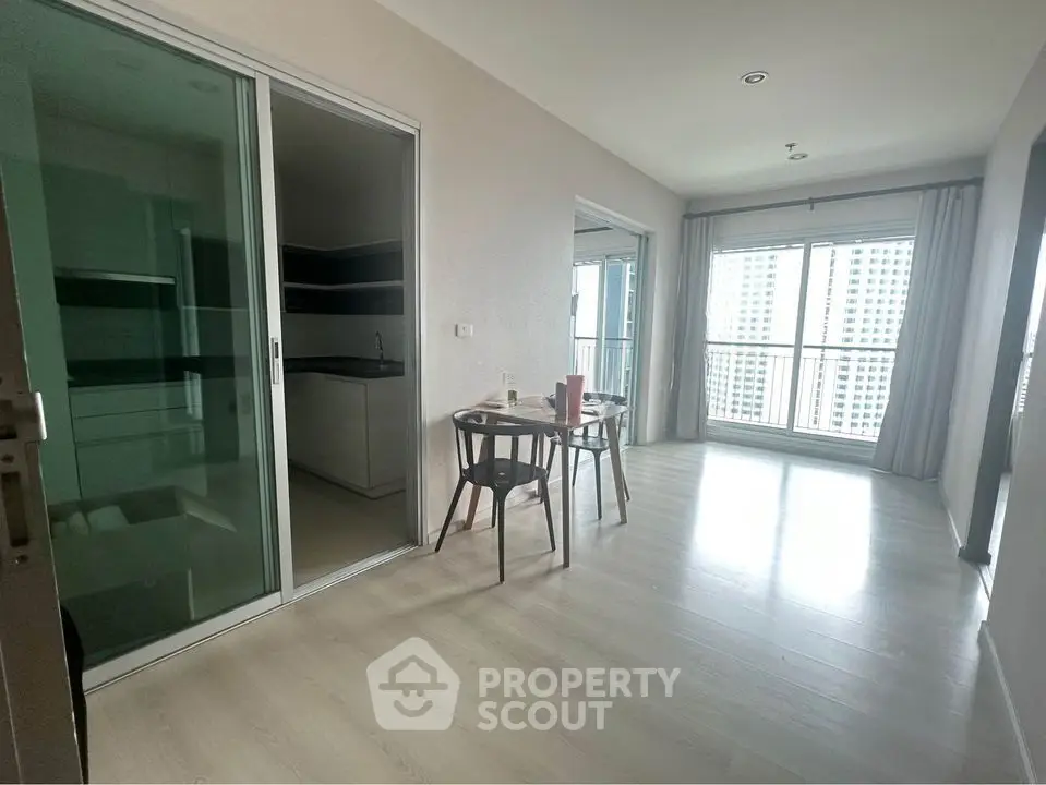 Spacious modern apartment with open layout and large windows offering city views.