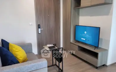 Modern living room with sleek furniture and flat-screen TV, perfect for cozy relaxation.