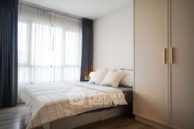 Modern bedroom with large window and stylish decor