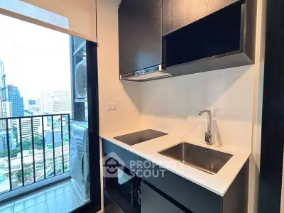 Modern kitchen with sleek cabinetry and city view from balcony
