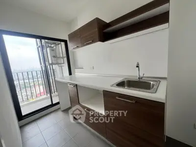 Modern kitchen with sleek cabinetry and balcony view