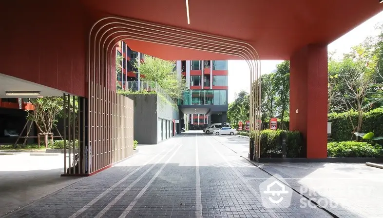 Modern building entrance with sleek design and spacious driveway