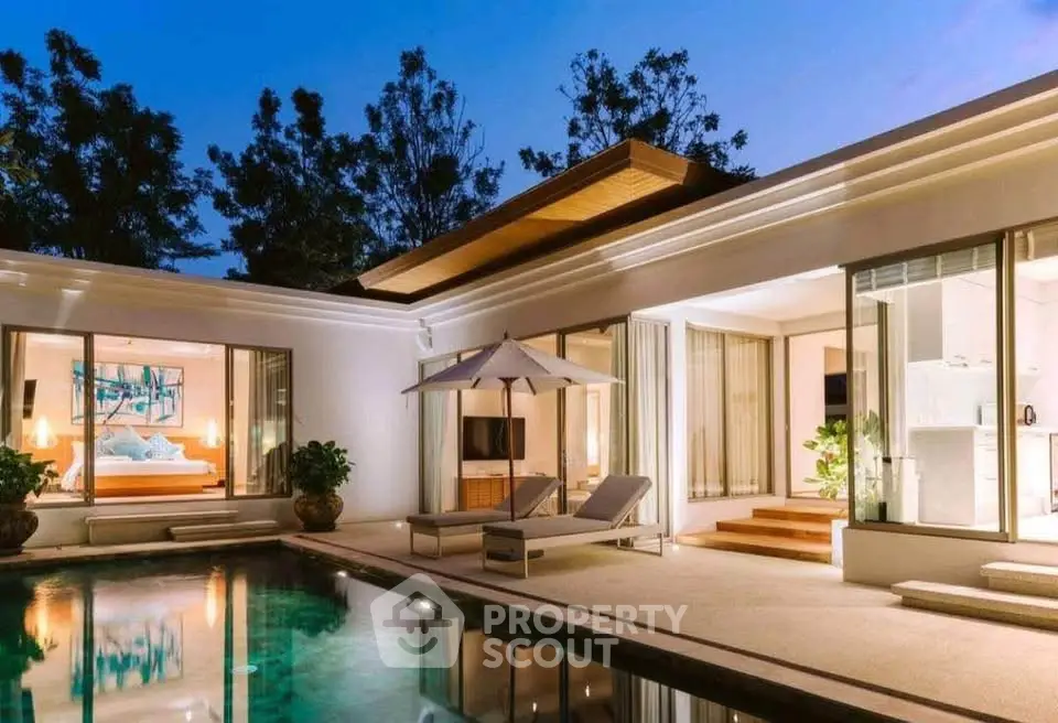 Luxurious modern villa with poolside view and elegant lighting at dusk.