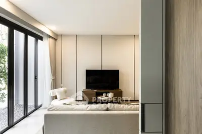 Modern living room with sleek design and large windows offering natural light.