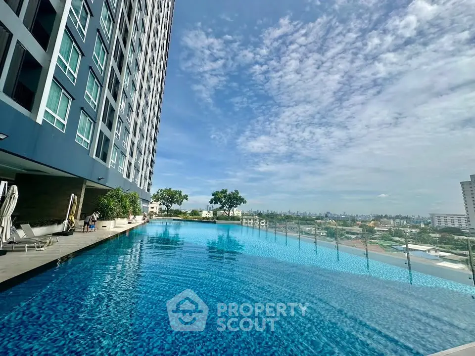 Luxurious high-rise building with stunning infinity pool and panoramic city views.
