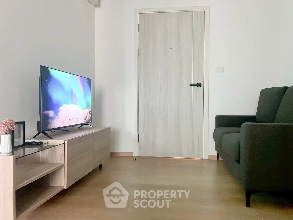 Modern living room with sleek TV setup and comfortable sofa, perfect for relaxation.