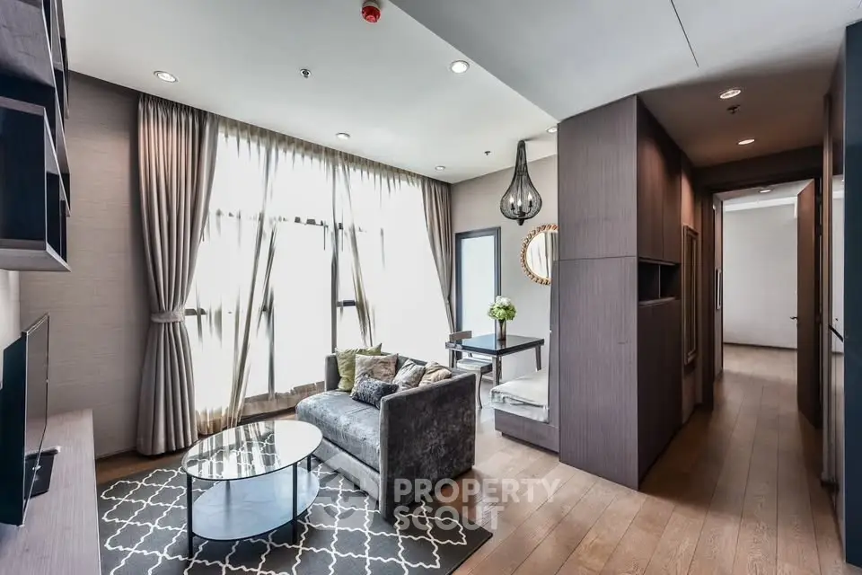 Modern living room with elegant decor and large windows in a stylish apartment.