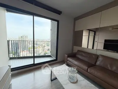 Modern living room with leather sofa and city view balcony in high-rise apartment.