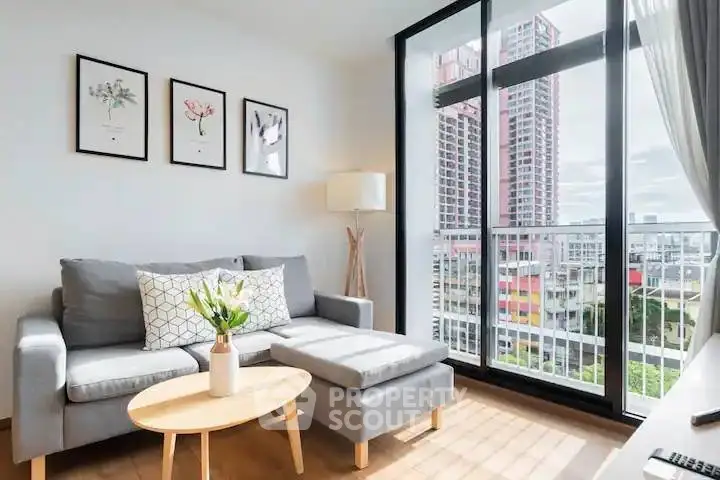 Modern living room with large windows and city view, featuring stylish decor and comfortable seating.