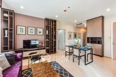 Modern living room with stylish decor and dining area in open layout apartment.