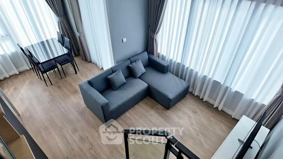 Spacious modern living room with large windows and stylish furniture