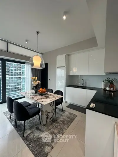 Modern kitchen with sleek design, marble dining table, and city view balcony.