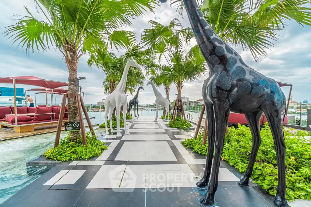 Luxurious rooftop with artistic giraffe sculptures and lush greenery offering stunning city views.