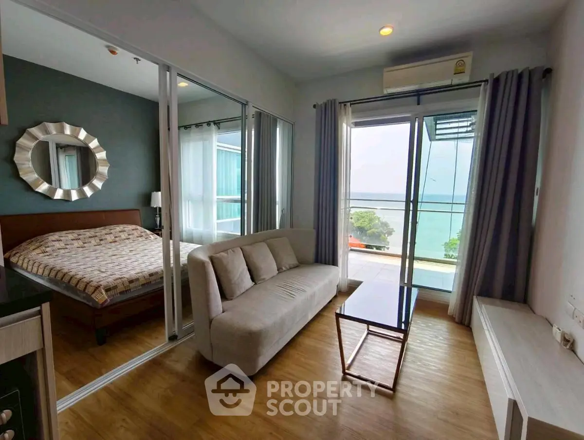 Modern condo with sea view, featuring a cozy living area and stylish bedroom.