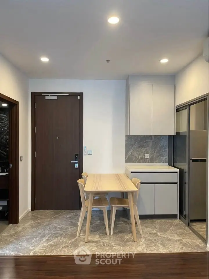 Modern apartment interior with dining area and sleek kitchen design