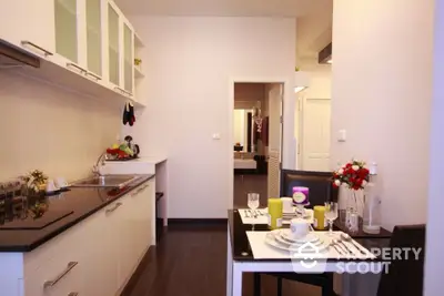 Modern kitchen with sleek cabinets and dining area in stylish apartment