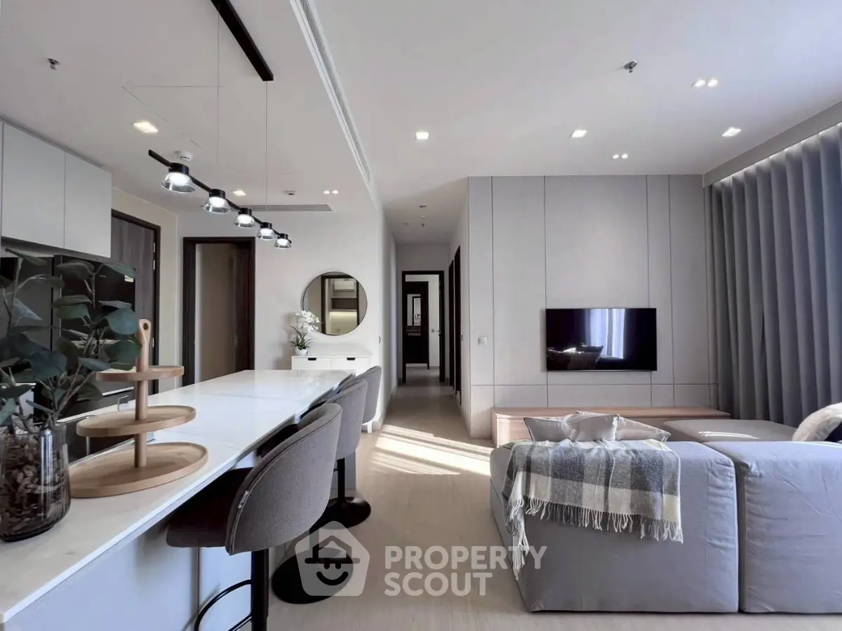 Modern open-plan living room with sleek design and cozy seating area