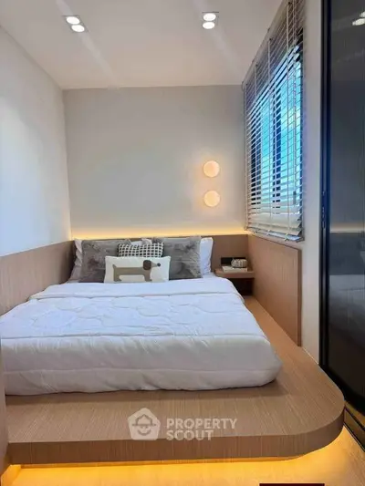 Modern minimalist bedroom with platform bed and ambient lighting