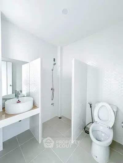 Modern bathroom with sleek white tiles and contemporary fixtures
