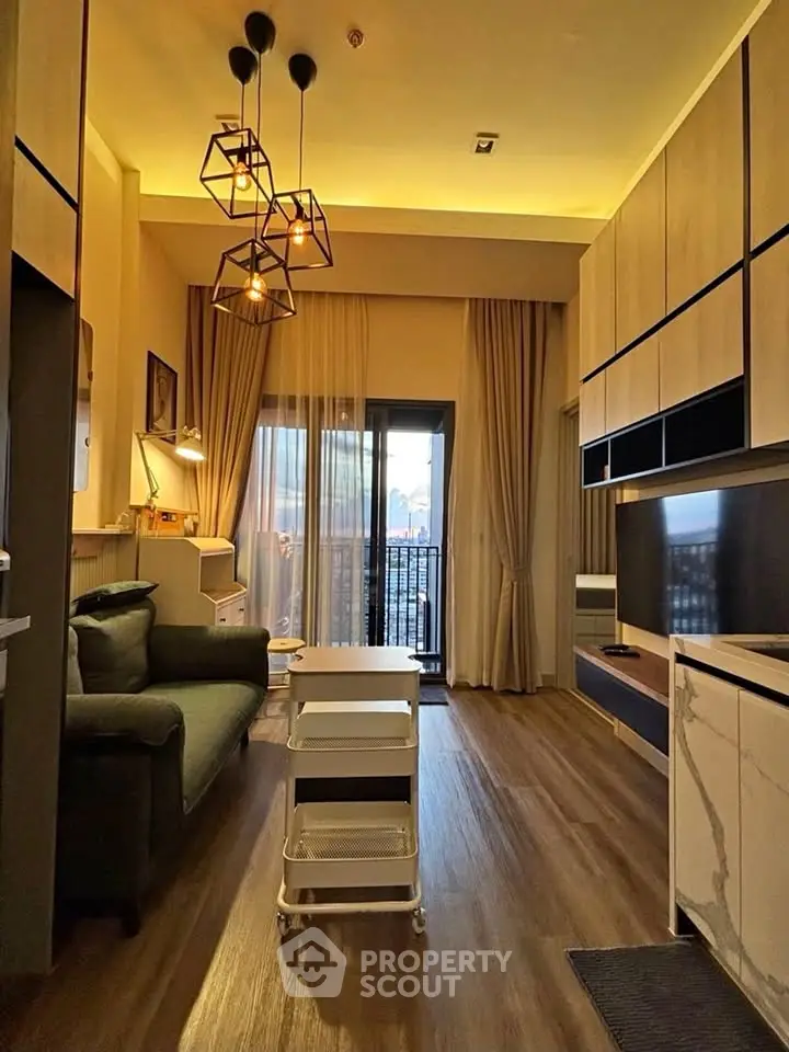 Modern living room with stylish lighting and balcony view in a cozy apartment.