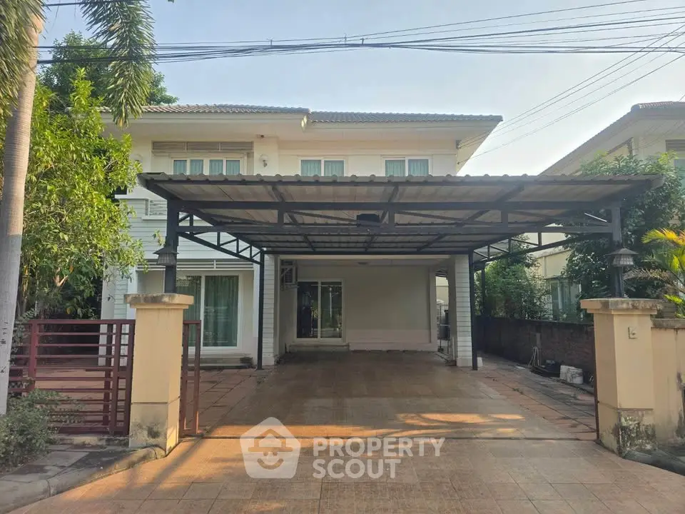 Spacious two-story house with large driveway and covered parking area.