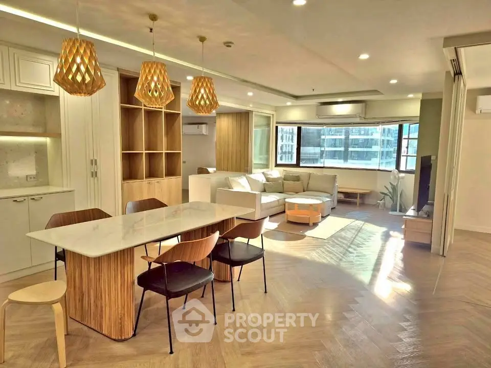 Spacious modern living room with open kitchen and stylish lighting in a luxury apartment.