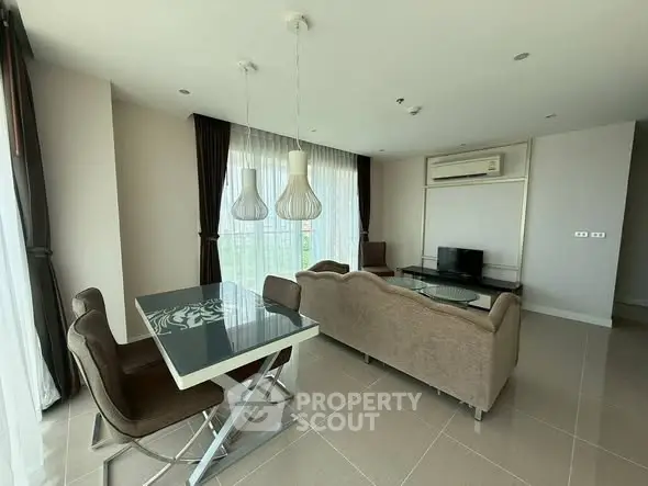 Spacious modern living room with elegant dining area and large windows