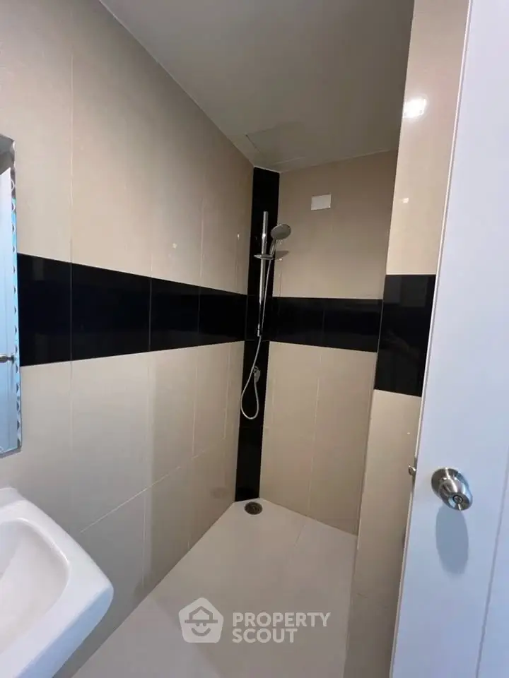 Modern bathroom with sleek shower design and neutral tiles
