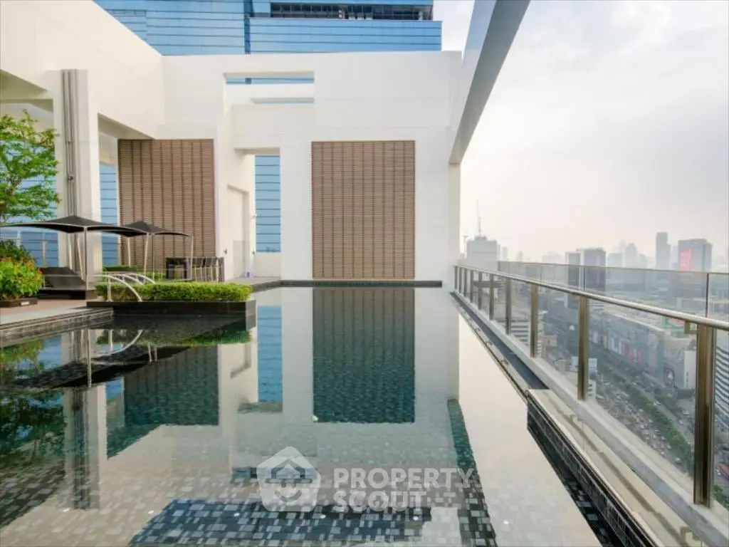 Luxurious rooftop pool with stunning city views in modern high-rise building.