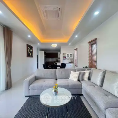 Spacious modern living room with elegant lighting and cozy seating area