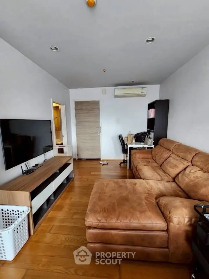 Spacious living room with modern furniture and wooden flooring