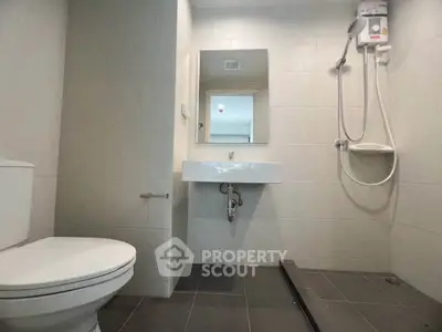 Modern bathroom with sleek fixtures and walk-in shower in a contemporary apartment.
