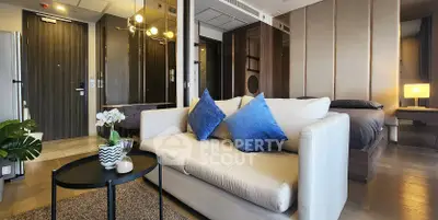 Modern living room with stylish decor and cozy seating in an open-concept apartment.