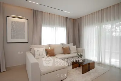 Elegant living room with modern decor and large windows for natural light