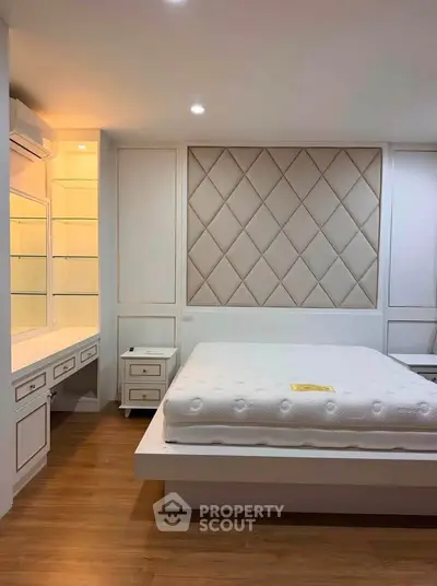 Luxurious bedroom with elegant paneling and modern furnishings, perfect for a serene retreat.