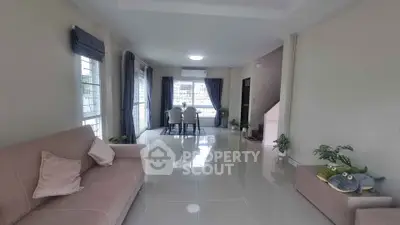 Spacious living room with modern decor and large windows