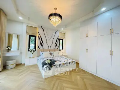Luxurious bedroom with elegant chandelier and modern decor