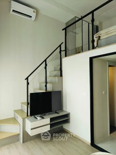 Modern loft apartment with mezzanine bedroom and sleek staircase design