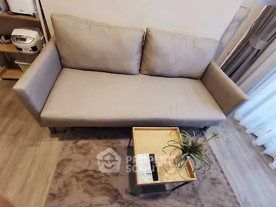 Modern living room with cozy gray sofa and stylish coffee table, perfect for relaxation and entertaining guests.