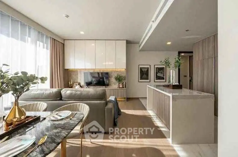 Luxurious open-plan living room with modern decor and abundant natural light.