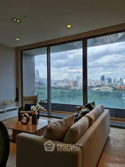 Luxurious living room with stunning city skyline view through large glass doors.