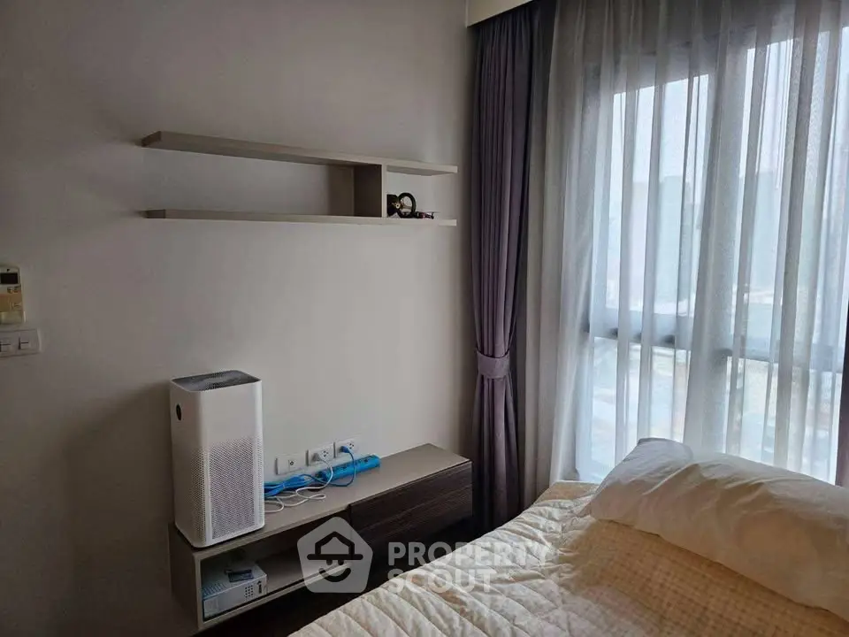 Cozy bedroom with modern shelving and air purifier, featuring large window with city view.