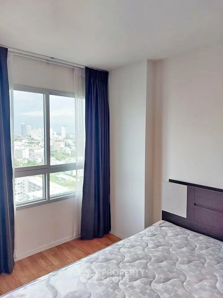 Bright bedroom with city view and modern decor in high-rise apartment