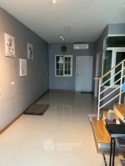 Modern interior hallway with sleek staircase and stylish wall art
