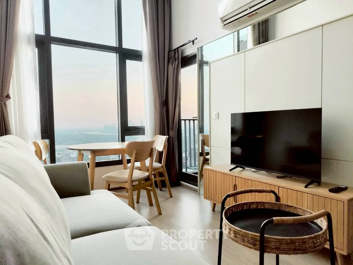 Modern living room with panoramic city view, stylish furniture, and large windows for natural light.