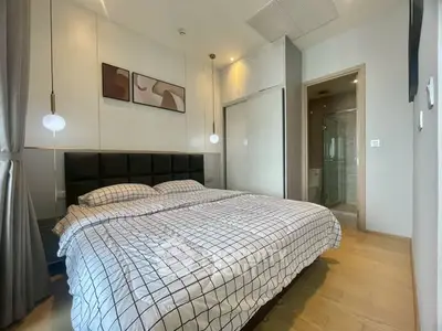 Modern bedroom with stylish decor and ensuite bathroom in a luxury apartment.