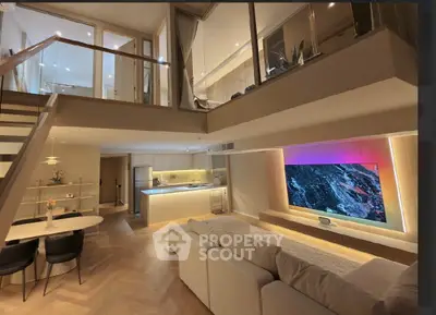 Luxurious modern living room with open kitchen and stylish mezzanine, featuring elegant lighting and sleek design.