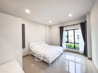 Bright and airy bedroom with large window and modern decor