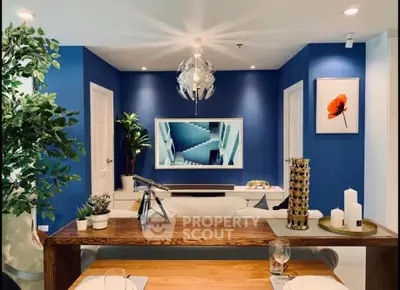 Stylish modern living room with blue accent wall and elegant decor